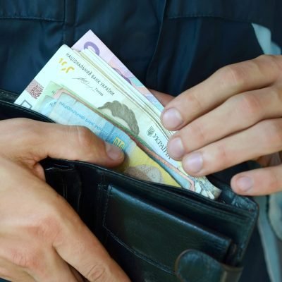 Close up male hands opened the wallet or purse with ukrainian money currency hryvnia Close up male hands opened the wallet or purse with ukrainian money currency hryvnia. Salary in Ukraine. Big amount of money